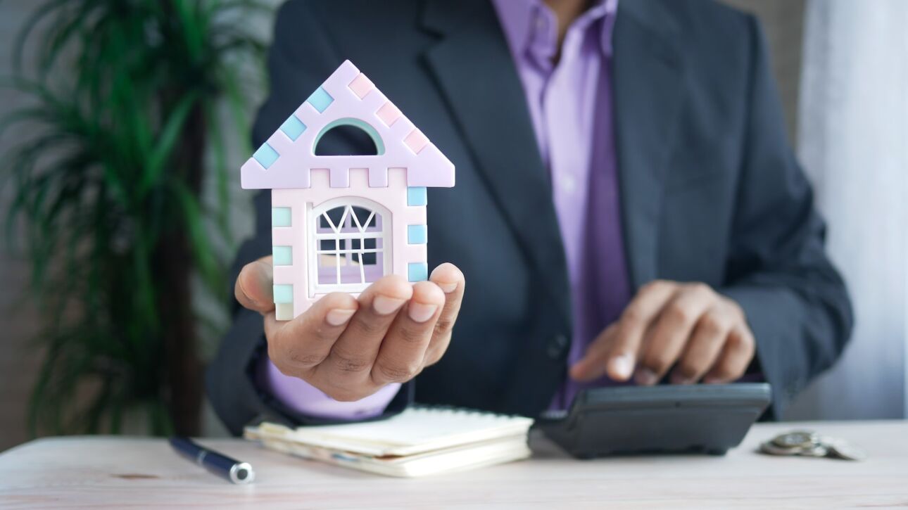mortgage lender holding a model house